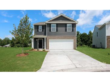 Charming two-story home featuring a spacious two-car garage, beautifully landscaped yard, and classic architectural details at 3025 Ora Smith Rd, Lincolnton, NC 28092