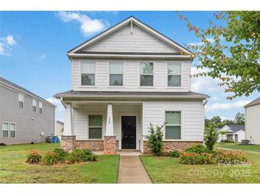 Charming two-story home featuring a covered porch with stone accents and well-manicured landscaping at 422 Nixon Rd, Belmont, NC 28012