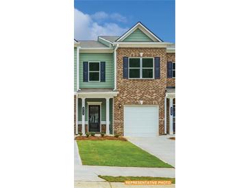 Charming townhouse with a brick and siding facade, a one car garage, and a neatly manicured front lawn at 6013 Jasmine Branch Rd, Charlotte, NC 28216