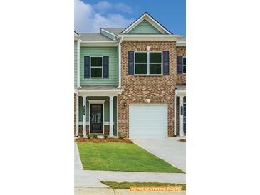 Charming townhome featuring a mix of brick and siding, an attached garage, and a neatly manicured lawn at 6013 Jasmine Branch Rd, Charlotte, NC 28216