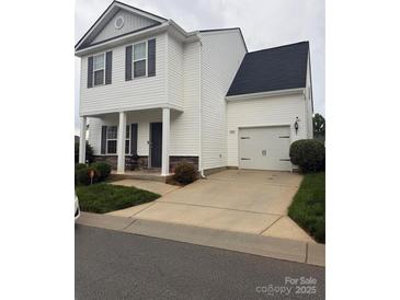 Charming two-story home with a garage, neat landscaping and a well-maintained lawn at 8005 Stevie Oaks Ln, Charlotte, NC 28215