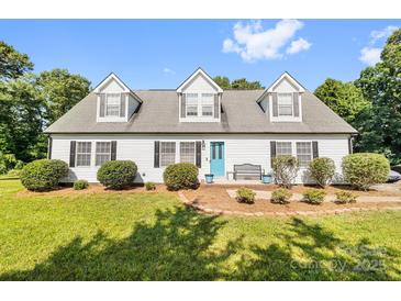 Charming single-Gathering home featuring a bright blue front door, complemented by a well-manicured lawn and lovely landscaping at 118 Grain Dr, Stony Point, NC 28678