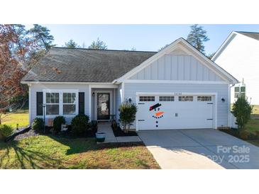 Charming single-story home with a well-maintained lawn and a delightful snowman decal on the garage door at 16142 Commodore Dr, Lancaster, SC 29720