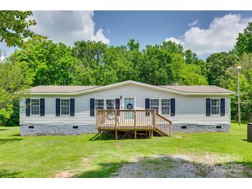 Charming one-story home featuring a front porch, well-manicured lawn, and fresh white siding at 284 Cedar Grove Rd, Clover, SC 29710