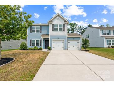 Charming two-story home with a two-car garage, nicely landscaped yard, and inviting curb appeal at 3107 Riker St, Clover, SC 29710