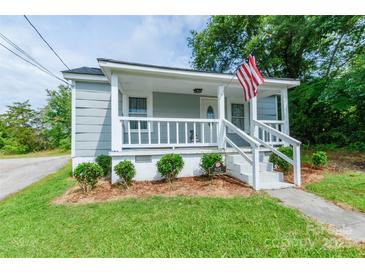Charming home with covered porch, landscaped front yard, and American flag at 515 Myrtle Ave, Chester, SC 29706