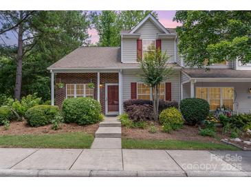 Charming two-story home featuring a well-maintained lawn with lush landscaping and a welcoming front entrance at 7121 Bidford Ct, Indian Land, SC 29707