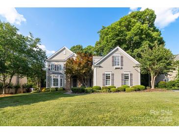 Charming two-story home featuring a beautifully landscaped front yard and a welcoming facade at 10927 Thornhill Club Dr, Charlotte, NC 28277
