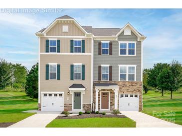 Charming attached two-story homes boasting manicured lawns and individual garages in a suburban setting at 2342 Nadine Ln, Charlotte, NC 28216