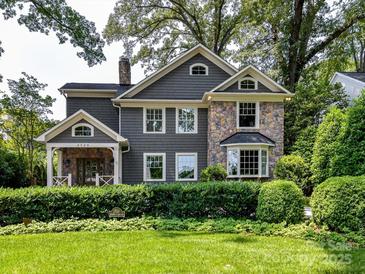 Charming two-story home with a stone facade and a lush green lawn at 2526 Sherwood Ave, Charlotte, NC 28207