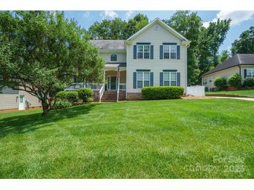 Charming two-story home with a well-manicured lawn and inviting front porch with blue shutters at 2908 Barnard Castle Ln, Matthews, NC 28104