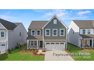 Charming two-story home featuring a gray exterior, well-manicured lawn, and a two-car garage at 32612-B Millingport Rd # 7157, New London, NC 28127
