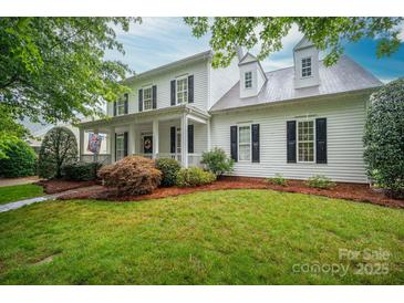 Traditional two-story home featuring a welcoming front porch, mature landscaping, and classic black shutters at 506 Academy St, Mcadenville, NC 28101