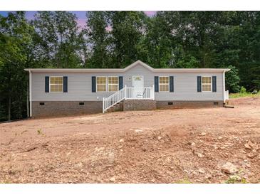 Charming single-Gathering home featuring gray siding, black shutters, and a welcoming front porch with white railings at 5090 Beaver Dam Way, Bessemer City, NC 28016