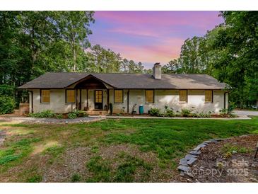 Charming single-story home with a brick facade, beautiful landscaping, and a cozy front entrance at 524 Heritage Vw, Indian Trail, NC 28079