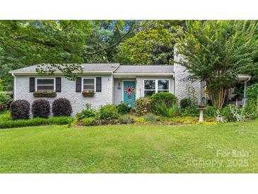 Charming cottage-style home with brick facade, colorful landscaping, and inviting front yard at 151 Cynthia St, Statesville, NC 28677