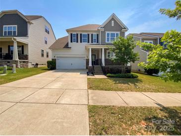 Charming two-story home with a well-maintained lawn and attached two-car garage at 1680 Trentwood Dr, Fort Mill, SC 29715