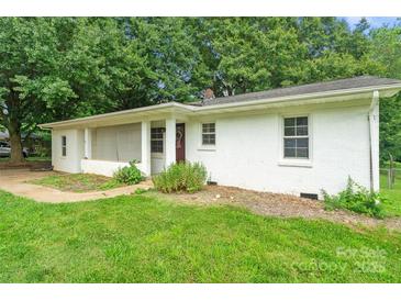 Charming single-story home featuring a white brick facade and a welcoming front porch at 2131 Lee St, Gastonia, NC 28054
