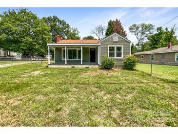 Charming single-story home featuring a covered front porch and well-maintained lawn at 2136 W 6Th Ave, Gastonia, NC 28052