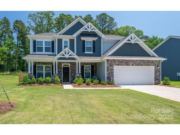 Charming two-story home with stone accents, manicured lawn, and a welcoming front porch at 250 Winford Rd, Troutman, NC 28166