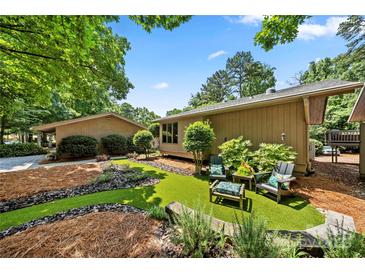 A peaceful backyard retreat with lovely landscaping and an inviting seating area for outdoor relaxation at 26 New River Trce, Lake Wylie, SC 29710