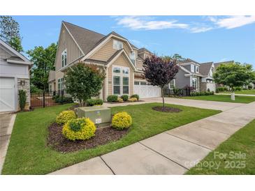 Beautiful two-story home with a well-manicured lawn and lovely landscaping at 3008 Laney Pond Rd, Matthews, NC 28104