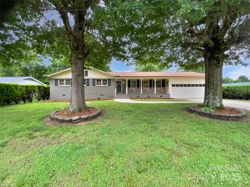 Charming single-story home with a welcoming front porch and mature trees shading the yard at 302 Melinda Ave, Kannapolis, NC 28083