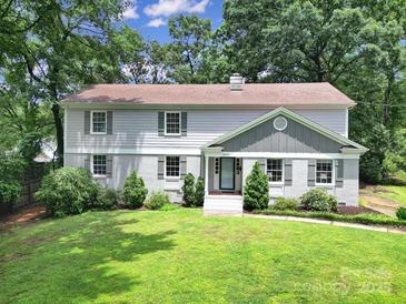 Charming two-story home with a manicured lawn and mature trees offering great curb appeal at 3800 Lovett Cir, Charlotte, NC 28210