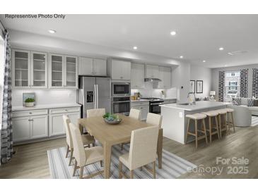 Bright, open-concept kitchen featuring stainless steel appliances and a large island with bar seating at 5048 Grain Orchard Rd # 3024G, Indian Trail, NC 28079