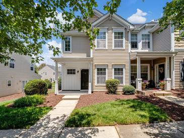 Charming townhome with a well-manicured lawn and welcoming front porch at 10446 Trolley Run Dr, Cornelius, NC 28031