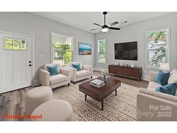 Bright living room featuring stylish furniture, modern entertainment center, and sunlit windows at 144 Walnut St, Chester, SC 29706