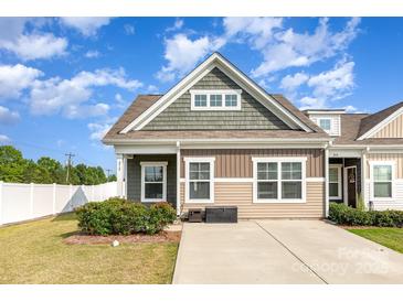 Charming exterior view of a two-story home with a well-manicured lawn and a paved driveway on a sunny day at 218 Canina Ln, Indian Trail, NC 28079
