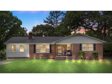 Charming brick home with manicured lawn, featuring updated lighting and inviting front porch at 2536 Cambridge Dr, Lancaster, SC 29720