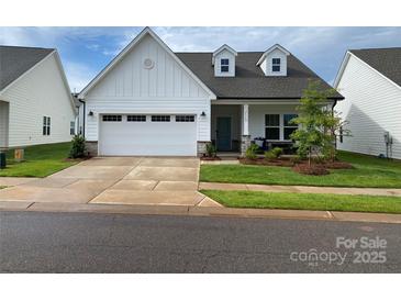 Charming, traditional home with a well-manicured lawn, dormer windows and a large attached garage at 25952 Appleyard Ct, Lancaster, SC 29720