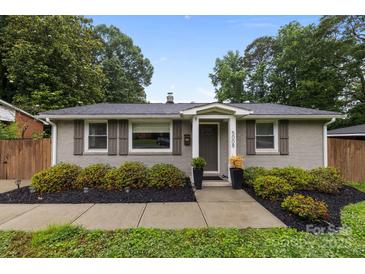 Charming brick home with well-maintained landscaping and a welcoming entrance with dark shutters at 5008 Unaka Ave, Charlotte, NC 28205