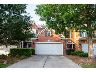 Charming brick home with mature trees, a two-car garage and a well-maintained lawn at 10433 Blairbeth St, Charlotte, NC 28277