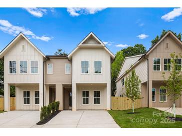 Charming new construction home with modern farmhouse-style, inviting curb appeal, and concrete driveway at 2413 Pruitt St, Charlotte, NC 28208