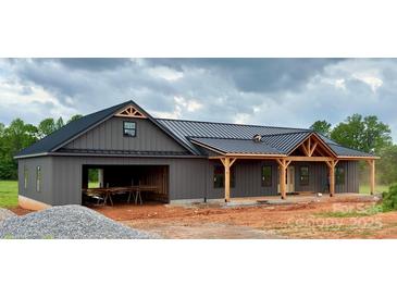 New construction home features board and batten siding and a covered front porch at 3000 Paul Payne Store Rd, Taylorsville, NC 28681