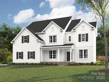 Stunning new construction featuring a classic white exterior, black shutters, and covered front porch at 11009 Tyler Brook Ln # Oak0043, Mint Hill, NC 28227