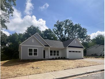 Charming single-story home with white siding, attached garage, and freshly mulched front yard at 1312 W Monroe Rd, Salisbury, NC 28144