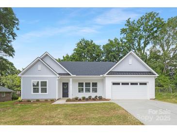 Charming single-Gathering home featuring a two-car garage and manicured front lawn with beautiful landscaping at 1312 W Monroe Rd, Salisbury, NC 28144