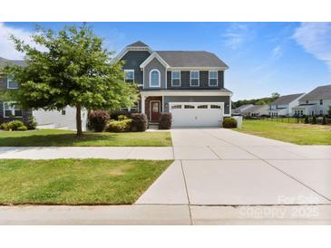 Charming two-story home with a manicured front lawn and a spacious two-car garage at 207 Welcombe St, Mooresville, NC 28115