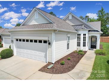 Charming home featuring a two-car garage, manicured landscaping, and inviting front entrance at 21214 W Tern Ct, Fort Mill, SC 29707