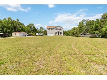 Two-story home on sprawling lawn with vehicles, boats, and recreational equipment at 3401 Shillinglaw Rd, Sharon, SC 29742