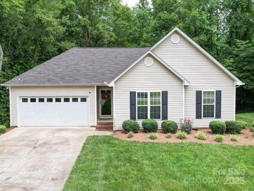 Charming single-story home featuring a well-manicured lawn and an attached two-car garage at 727 Cove Rd, Gastonia, NC 28052