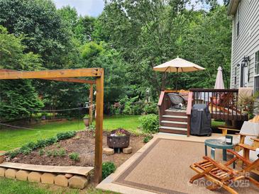 Outdoor space featuring a deck, patio, garden, and seating areas, perfect for relaxation and entertaining at 167 Foxtail Dr, Mooresville, NC 28117