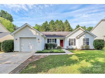 Charming home with a well-maintained front yard, lush green grass, and a welcoming red door at 1922 Decatur Ct, Charlotte, NC 28213