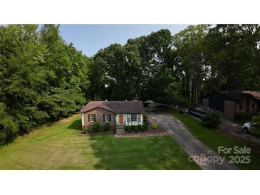 Charming single-story home with a brick facade and a well-manicured lawn at 214 Cottage Pl, York, SC 29745