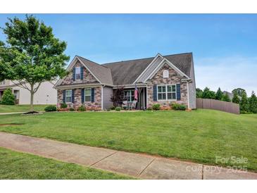 Charming home with stone accents, neat landscaping, and a well-manicured lawn at 246 Bushney Loop, Mooresville, NC 28115