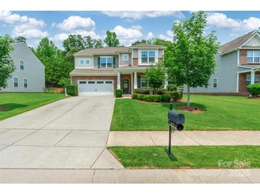 Charming two-story home with well-manicured lawn, brick accents, and a two-car garage at 261 Catoctin Rd, Rock Hill, SC 29732